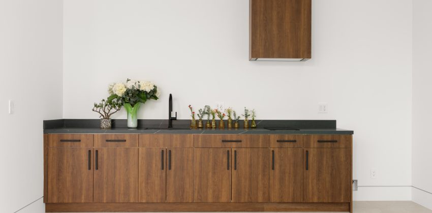 Custom wood cabinetry with black countertop and floating upper cabinet in a Manhattan Beach new home build